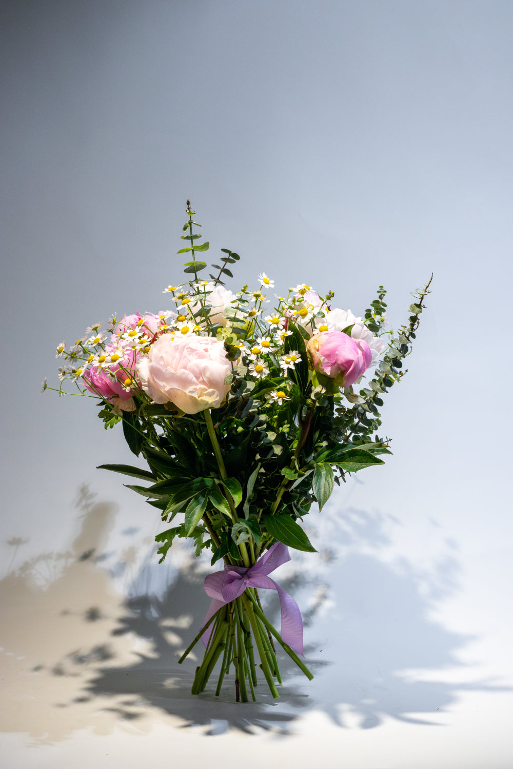Flower bouquet with peonies, tanacetum and eucaliptus